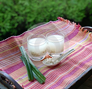 Barley water in glass and cooked pearly barley with pandan leaves