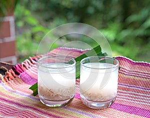 Barley water in glass and cooked pearly barley with pandan leaves