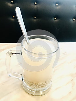 Barley water in glass. Vertical photo image.