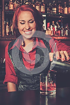 Barmaid making cocktail