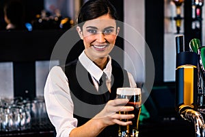 Barmaid serving a pint