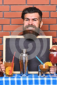 Barman, bartender or hipster holds bar advertising. Bar menu concept.