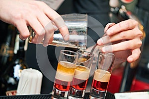 Barman or bartender preparing alcohol cocktail in restaurant