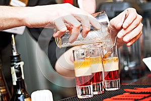 Barman or bartender preparing alcohol cocktail in restaurant