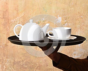 Barman brings tea or coffee. Service and restaurant catering concept