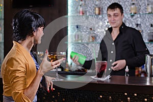 Barman chatting with a female customer