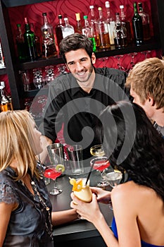 Barman chatting with friends drinking at bar photo