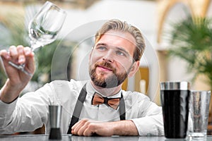 Barman checking the cleanliness of glass
