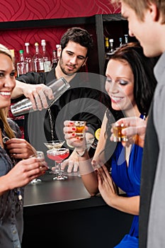 Barman cocktail shaker friends drinking at bar
