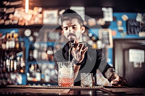 Barman creates a cocktail on the saloon