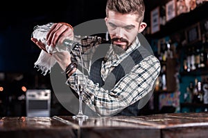 Barman formulates a cocktail at the taproom