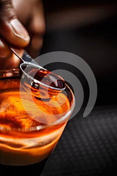 Barman hand pouring alcohol