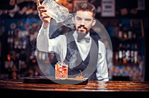 Barman makes a cocktail in the beerhouse