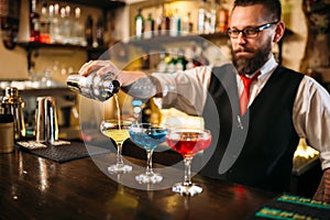 Barman making alcohol cocktails in nightclub