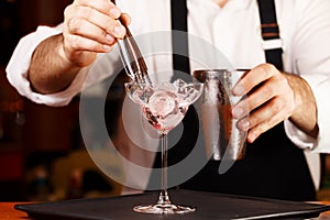 Barman in making cocktail at a nightclub. Nightlife concept.