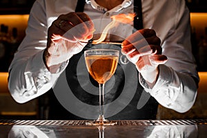 Barman making a fresh alcoholic drink with a smoky note