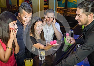 Barman performing magic Trick to surprised Guest