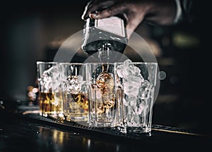 Barman pouring alcoholic drink