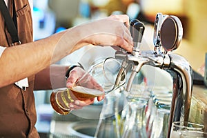 Barman pouring beer photo