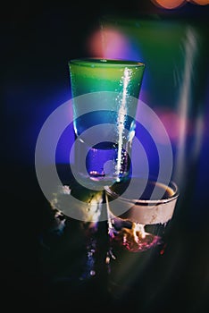 Barman pouring a shot of liquor into glass