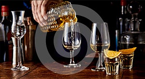 Barman pouring spirits from a cut glass decanter