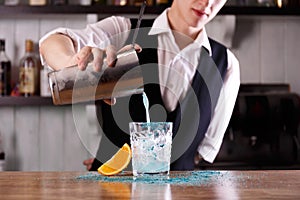 A barman prepares a Blue Lagoon coctail