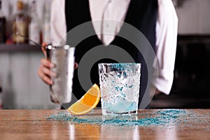 A barman prepares a Blue Lagoon coctail