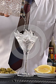 Barman preparing cocktail.
