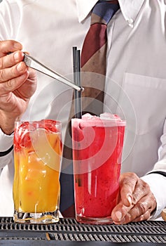 Barman preparing cocktail.