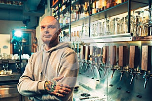 Barman in a pub near beer taps