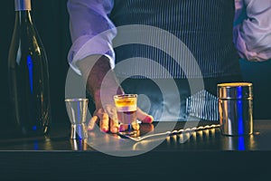 Barman serving B 52 cocktail