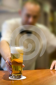 Barman serving beer