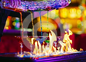 Barman show. Bartender pours alcoholic cocktails on the bar