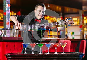 Barman show. Bartender pours alcoholic cocktails in a restaurant.