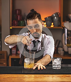 Barman stirring fresh alcoholic cocktail