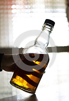 Barman taking a bottle of whiskey photo