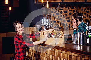 Barman and waiter work together with the team at the bar restau