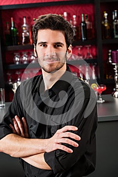 Barman wear black standing at cocktail bar photo