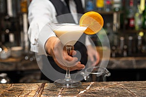 Barman at work, preparing cocktails. Serving pina colada.