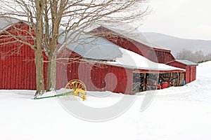 Barn and cultivator in snow, winter photo