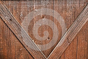 Barn door, weathered wood, cross beams create V pattern