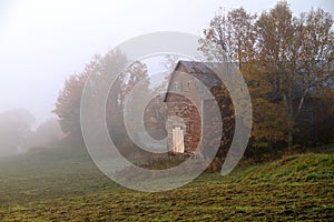 Barn in early morning fog