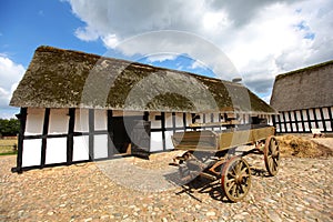 Barn farmhouse with wooden cart