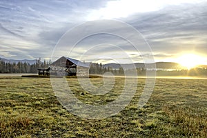 Barn in field at sunrise