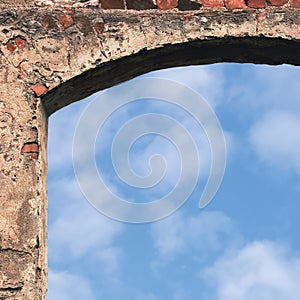 Barn gate door arch and sky, stone wall closeup, vertical bright white summer clouds cloudscape copy space background, plastered