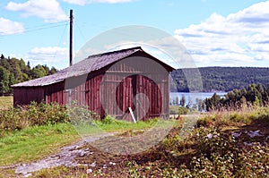 Barn on a hill by a lake