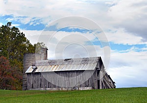 Barn on Hill With Roofless Silo photo