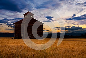 Barn silhouetted at sunset photo