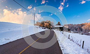 Barn and snow covered fields along a country road in rural York