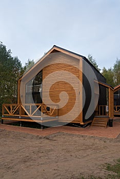 Barnhouse style house. House in the bosom of nature. Greenery and trees